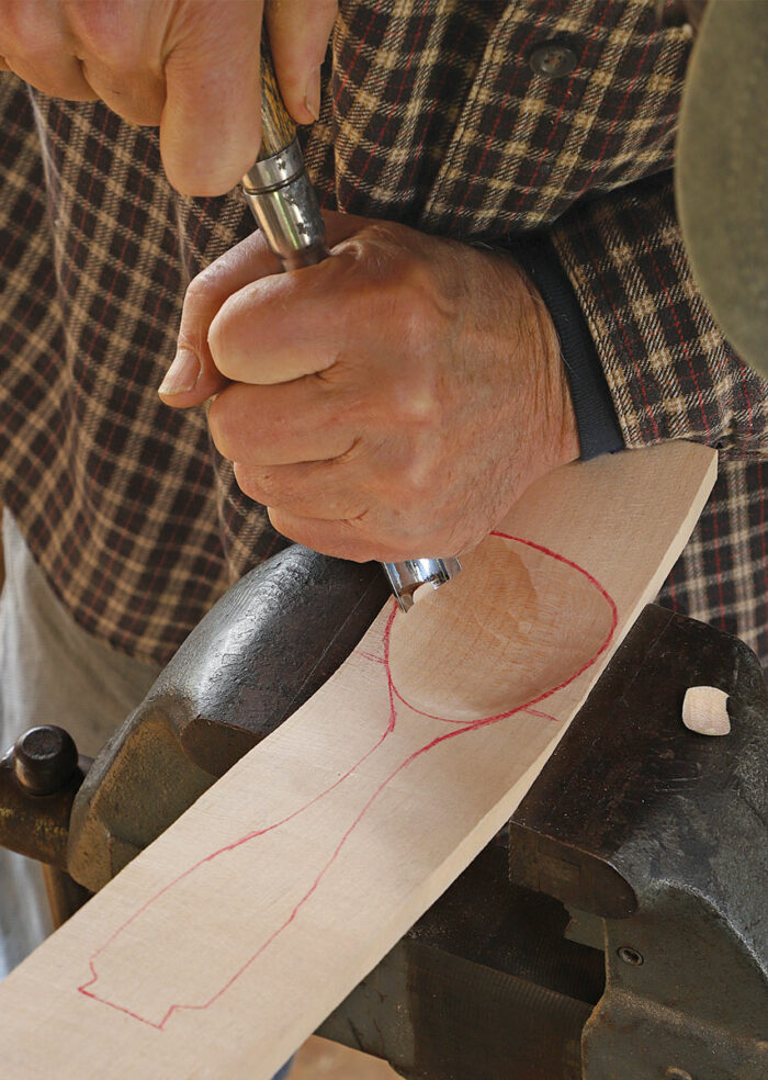 The bent blank starts out flat. Instead of searching in the woods for naturally bent spoon stock, as he used to do, Buchanan splits and shaves a chunk of green sugar maple and steam-bends it to create a curved blank.